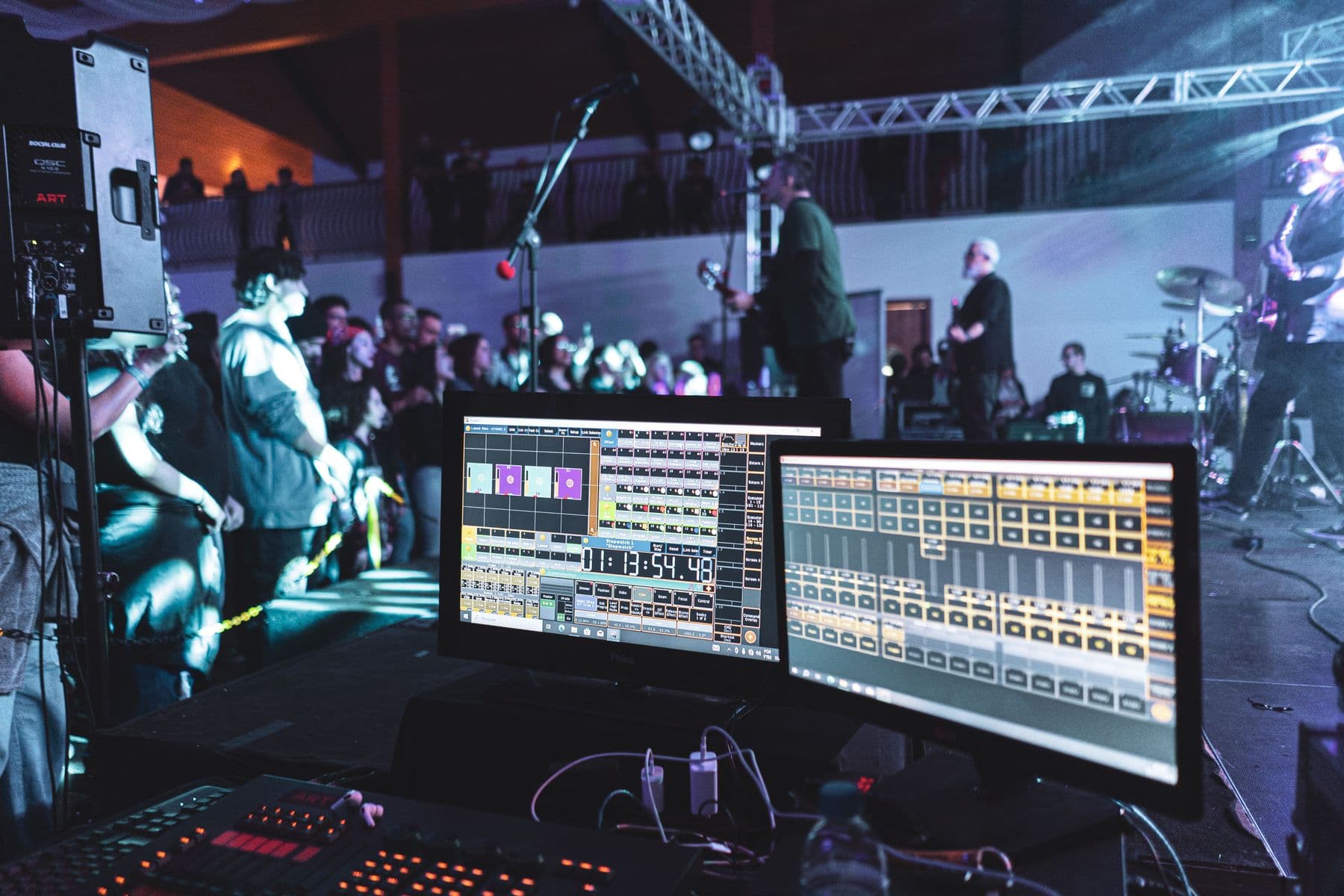 Live sound control operating during a concert with the stage visible beyond