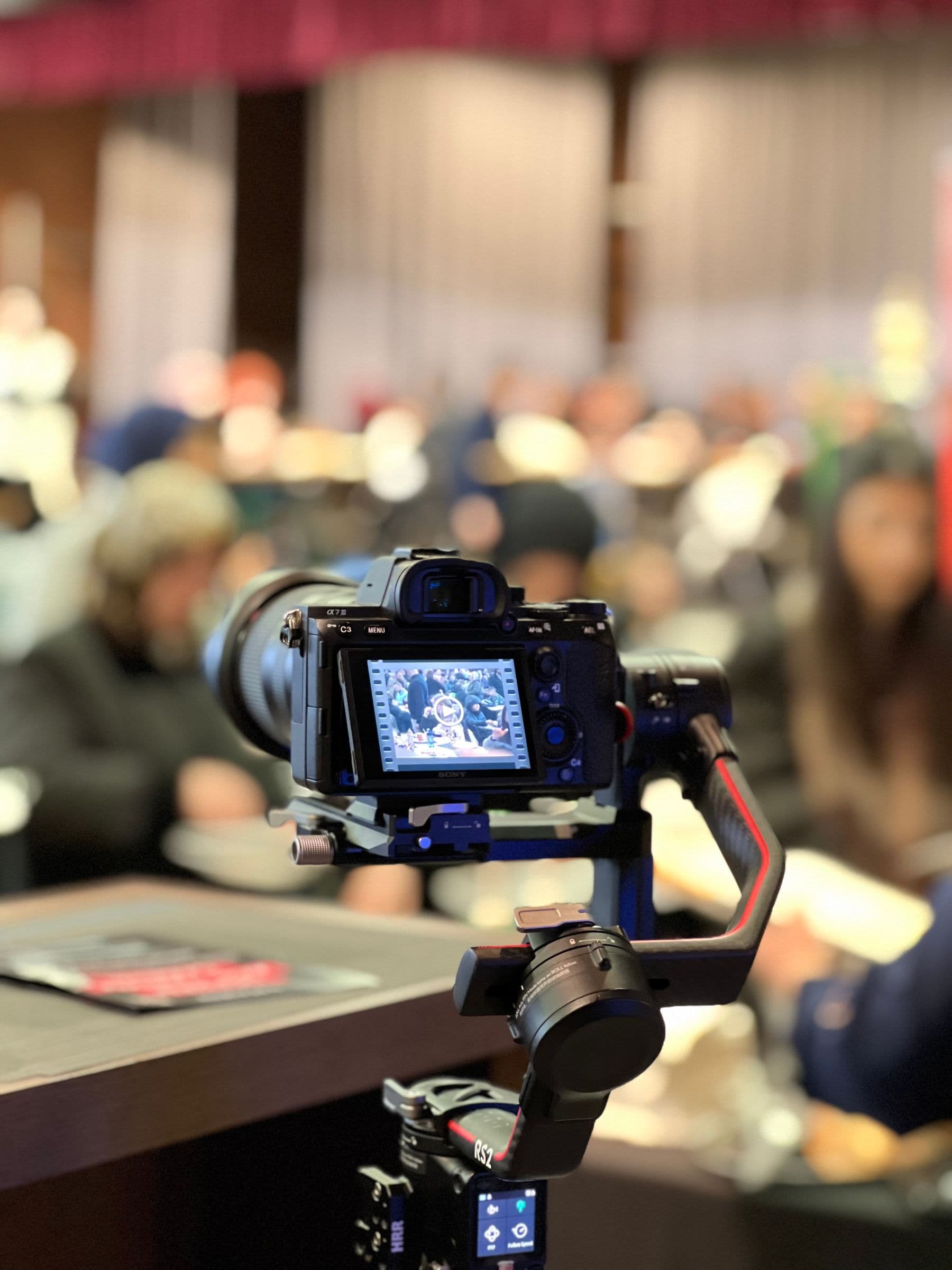 Professional video camera recording a live conference audience